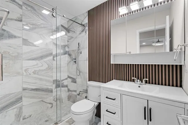 a bathroom with a toilet and a shower