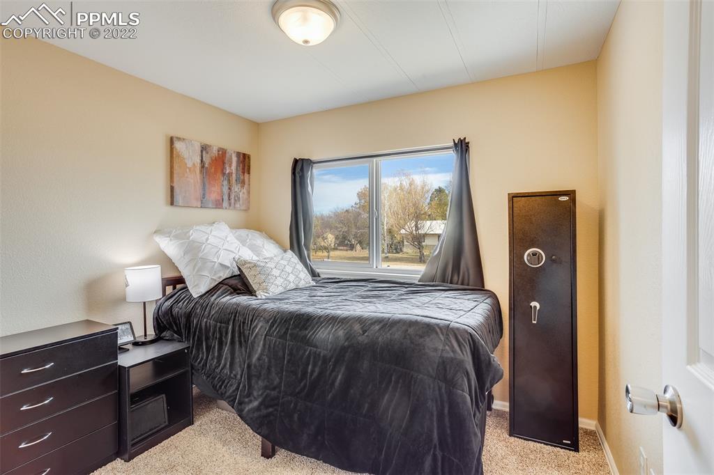315 Cheyenne Street Calhan, CO 80808 - Photo 13 of 28 a bedroom with a bed and a window