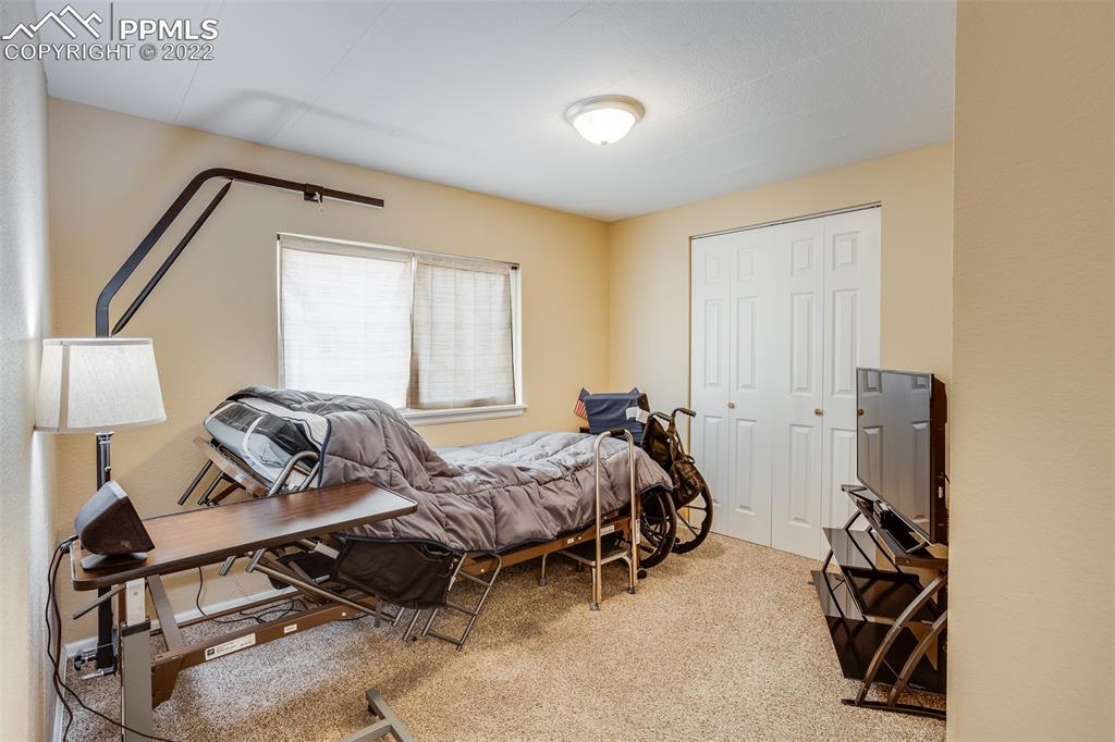 315 Cheyenne Street Calhan, CO 80808 - Photo 14 of 28 a bedroom with furniture and a window