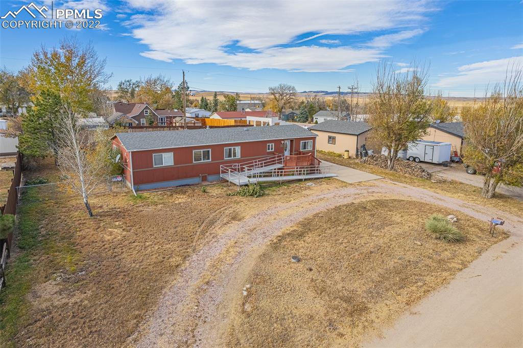 315 Cheyenne Street Calhan, CO 80808 - Photo 2 of 28 a view of a house with a yard