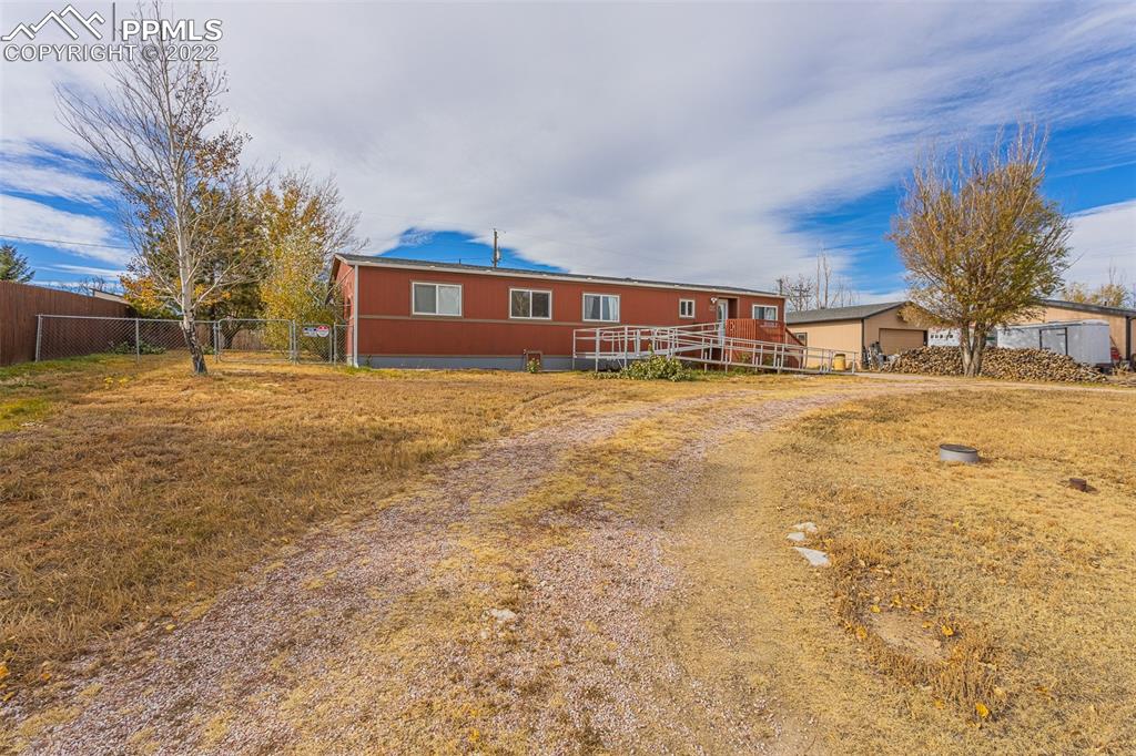 315 Cheyenne Street Calhan, CO 80808 - Photo 4 of 28 a view of a house with a yard