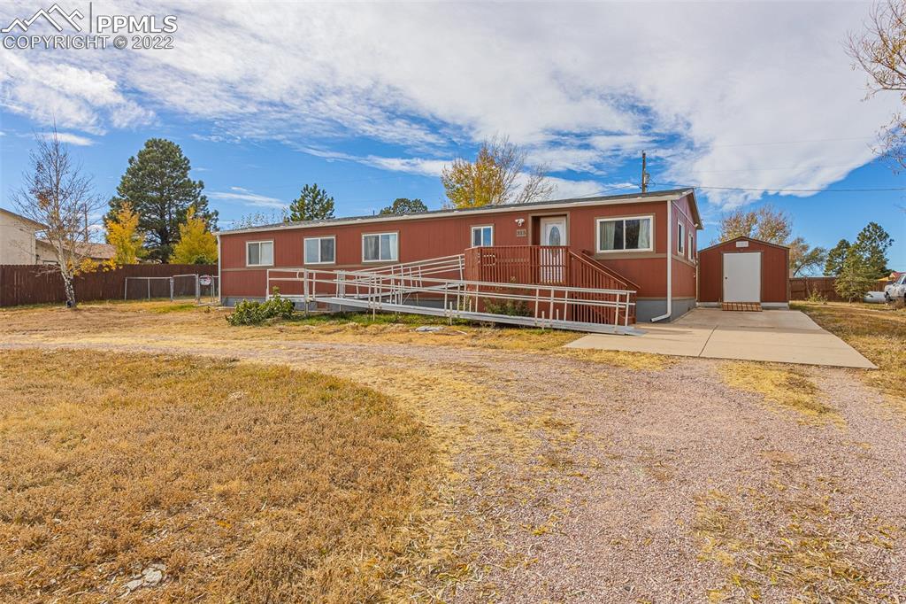 315 Cheyenne Street Calhan, CO 80808 - Photo 5 of 28 a front view of a house with a yard table and chairs