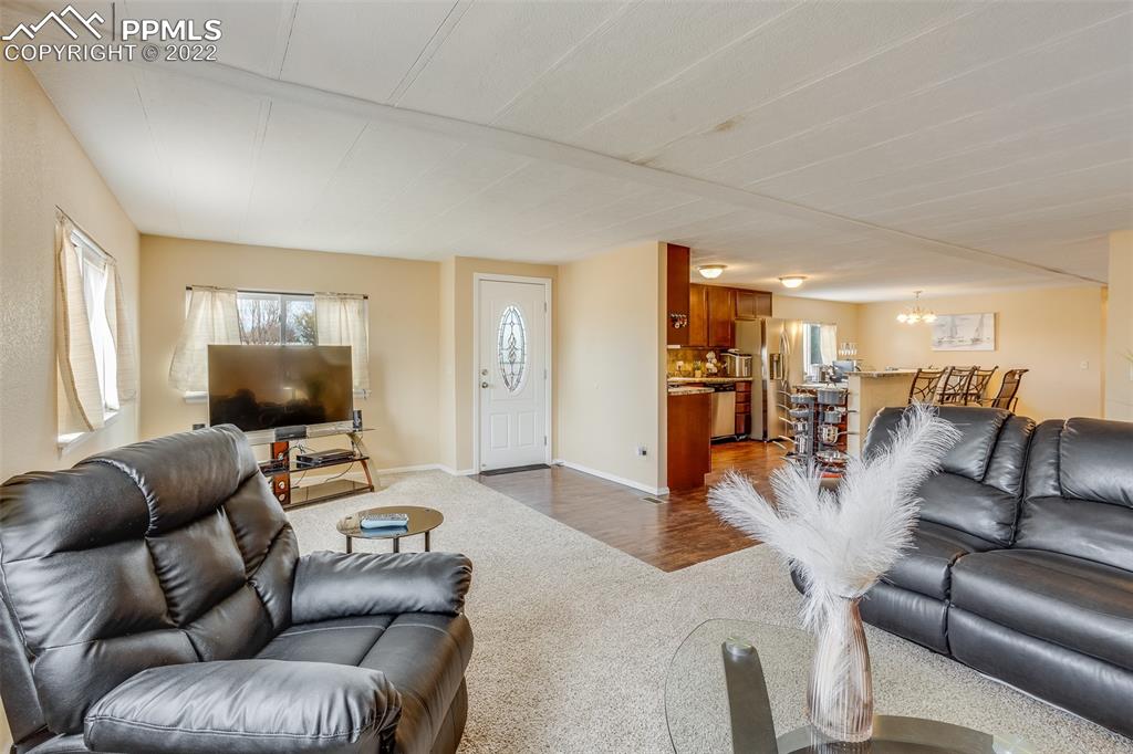315 Cheyenne Street Calhan, CO 80808 - Photo 7 of 28 a living room with furniture and a flat screen tv