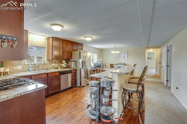 a large kitchen with a table and chairs