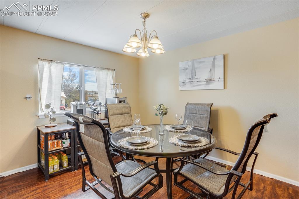 315 Cheyenne Street Calhan, CO 80808 - Photo 10 of 28 a view of a dining room with furniture window and wooden floor