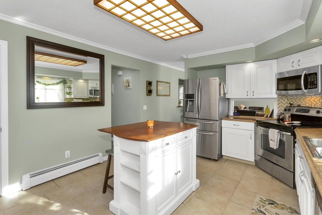 21 Brentwood Street Springfield, MA 01108 - Photo 14 of 41 a kitchen with stainless steel appliances granite countertop a stove a sink and a refrigerator