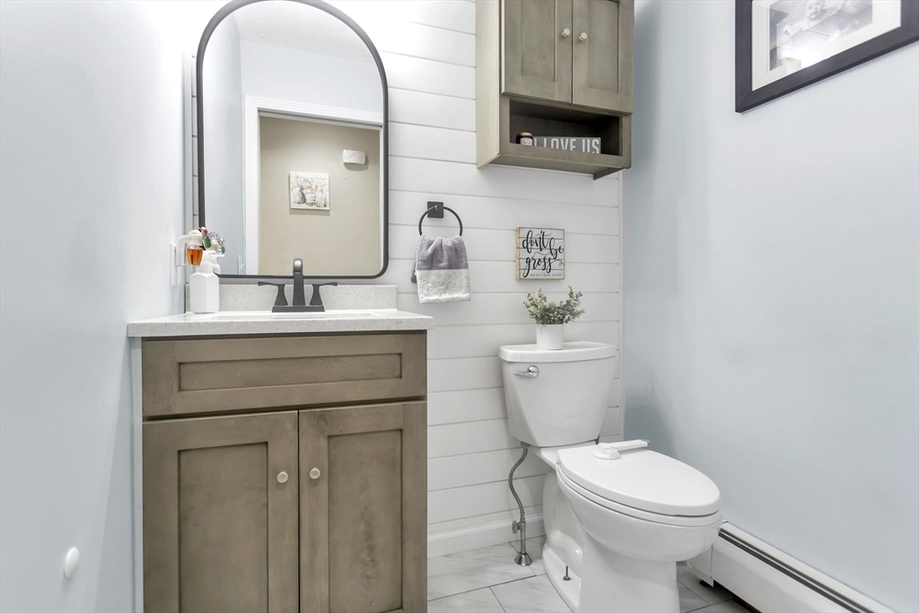 21 Brentwood Street Springfield, MA 01108 - Photo 19 of 41 a bathroom with a sink vanity mirror and toilet