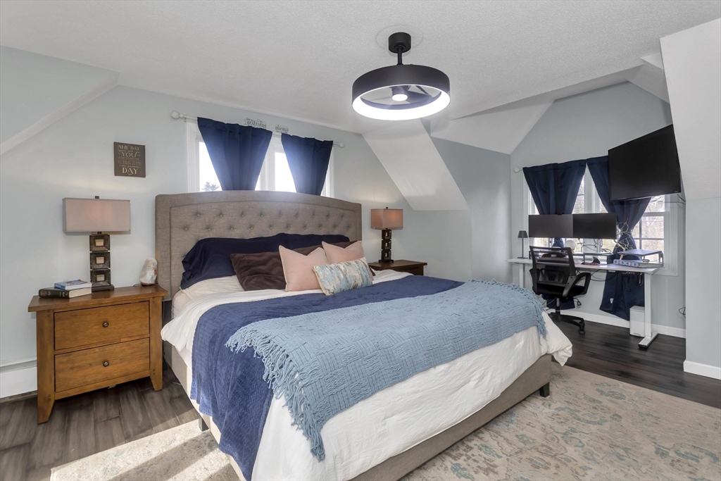 21 Brentwood Street Springfield, MA 01108 - Photo 20 of 41 a bedroom with a bed and a chandelier