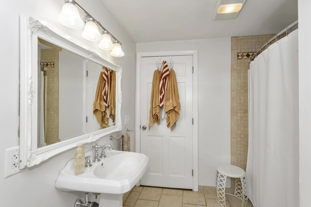 21 Brentwood Street Springfield, MA 01108 - Photo 26 of 41 a bathroom with a sink and mirror with bathtub