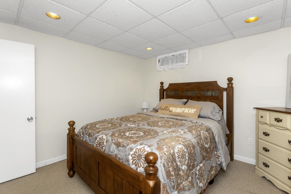 21 Brentwood Street Springfield, MA 01108 - Photo 32 of 41 a bedroom with a bed and window