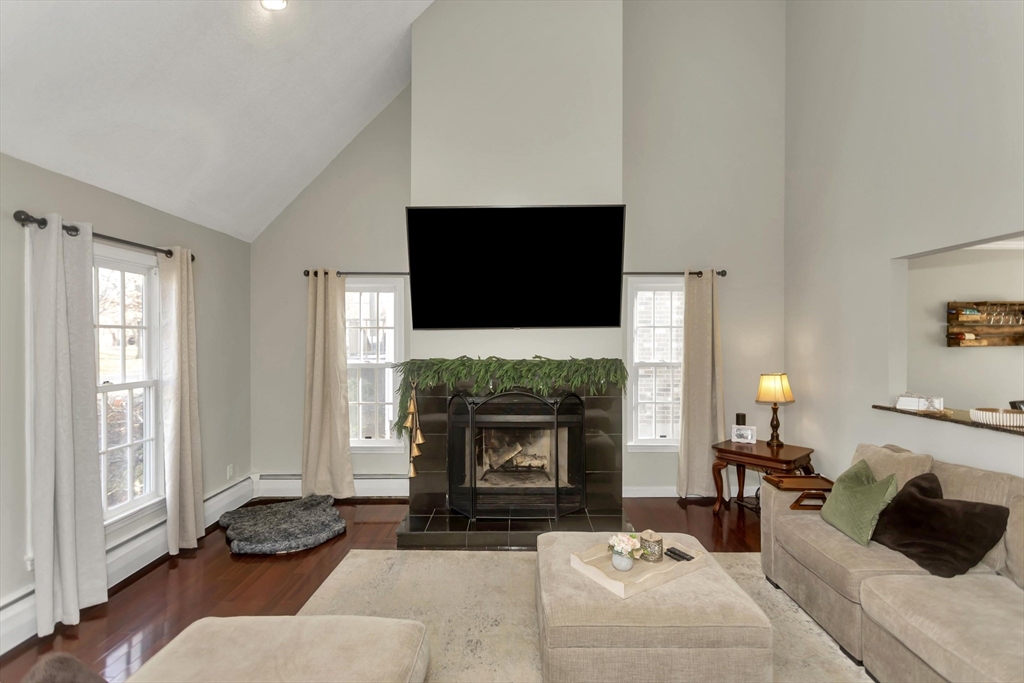 21 Brentwood Street Springfield, MA 01108 - Photo 7 of 41 a living room with furniture a fireplace and a flat screen tv