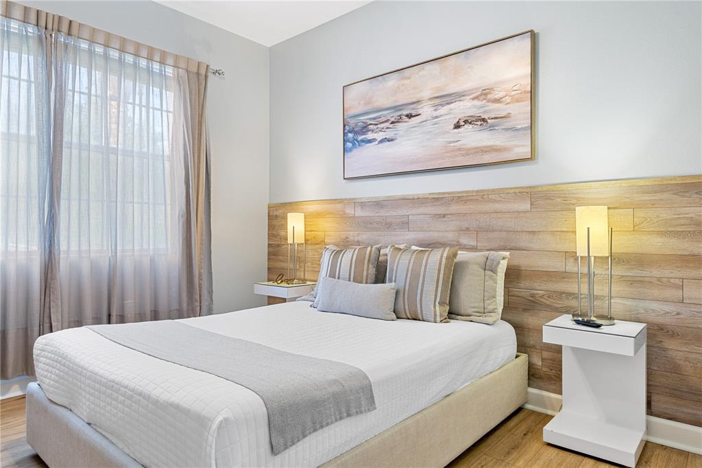 9006 Majesty Palm Road Kissimmee, FL 34747 - Photo 8 of 56 a bedroom with a bed and a painting on the wall