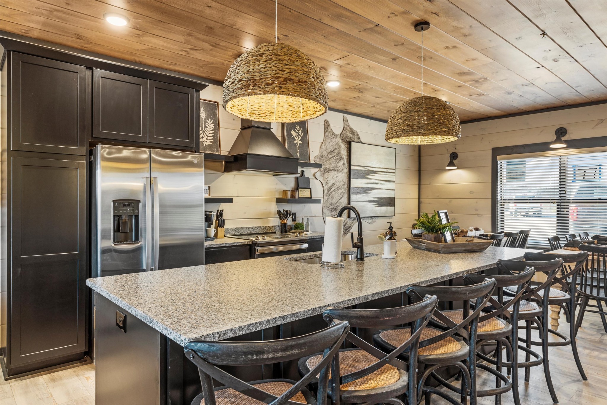 332 Rambling Creek Way Sevierville, TN 37862 - Photo 8 of 54 a kitchen with stainless steel appliances granite countertop a table chairs and a refrigerator