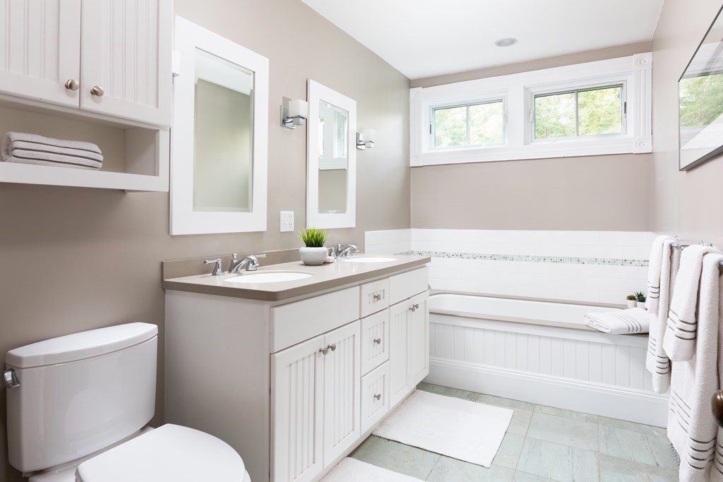 44 Putnam Street Newton, MA 02465 - Photo 20 of 24 a bathroom with a sink toilet vanity and tub