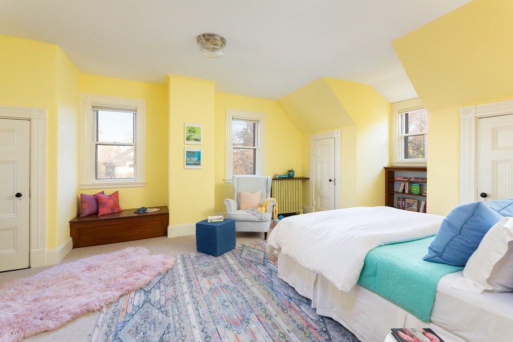 44 Putnam Street Newton, MA 02465 - Photo 21 of 24 a spacious bedroom with a bed and wooden floor