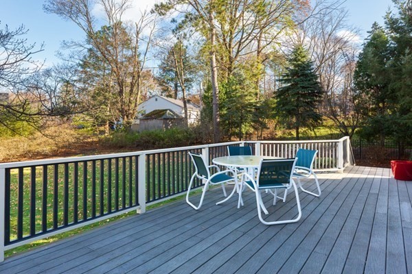 44 Putnam Street Newton, MA 02465 - Photo 4 of 24 a view of a deck with table and chairs and wooden floor