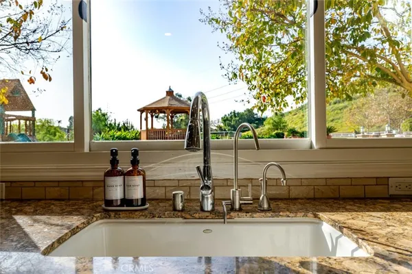 a kitchen with a sink stove and cabinets