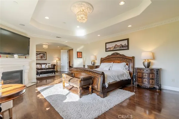 a bedroom with a bed and a wooden floor