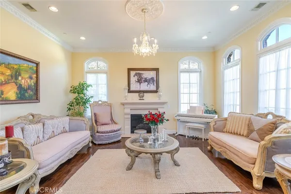 a view of a dining room with furniture and chandelier