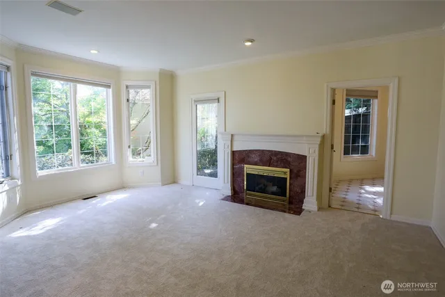 a view of empty room with a fireplace