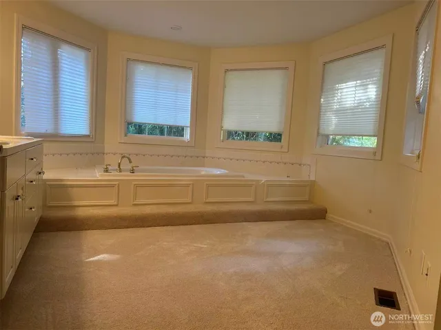 a bathroom with a bathtub and a window