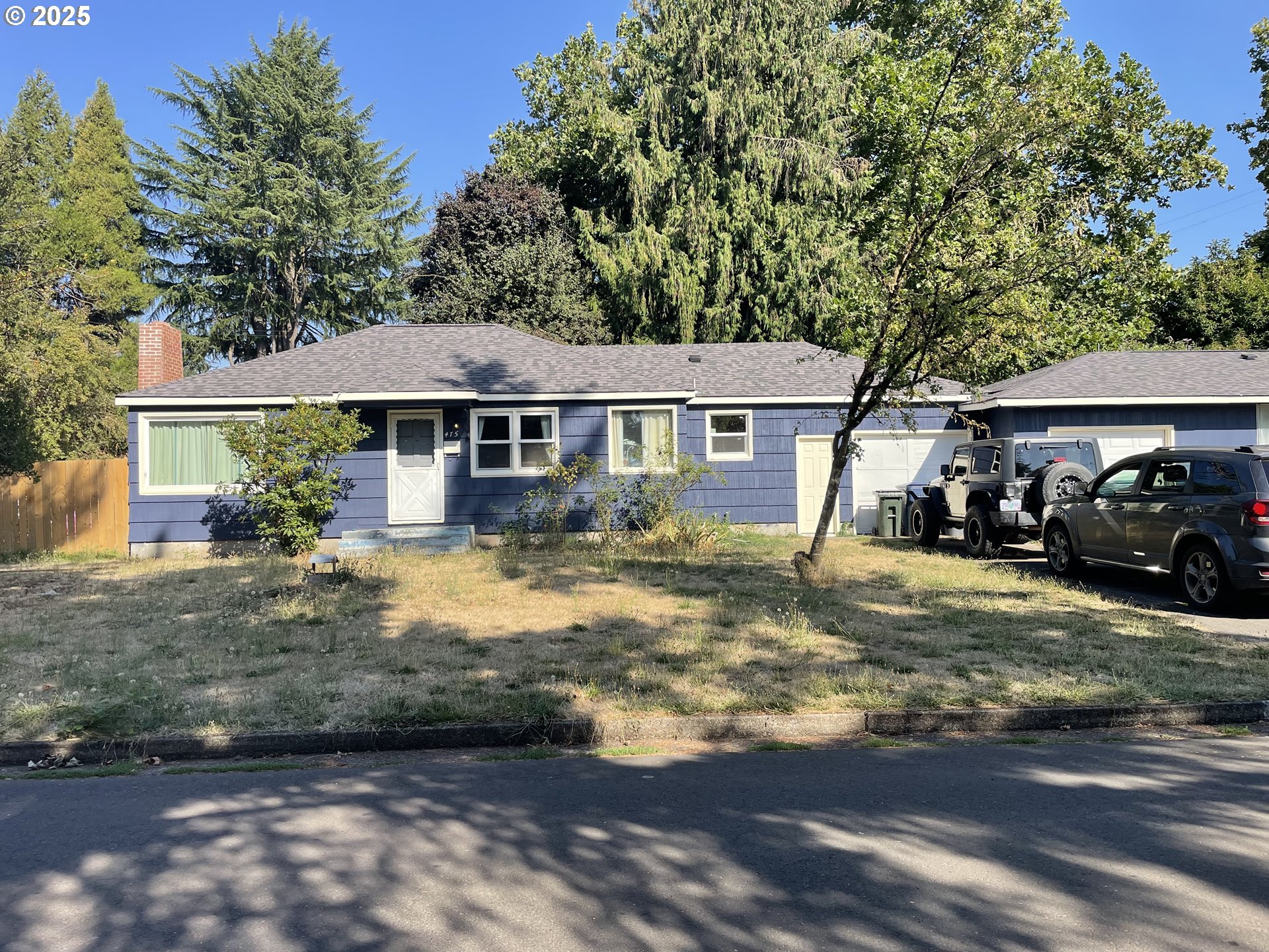 465 Davis Street Eugene, OR 97402 - Photo 2 of 11 a front view of a house with a garden and trees
