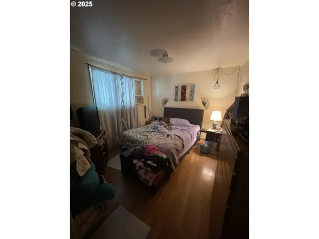 a bedroom with a bed and a night stand