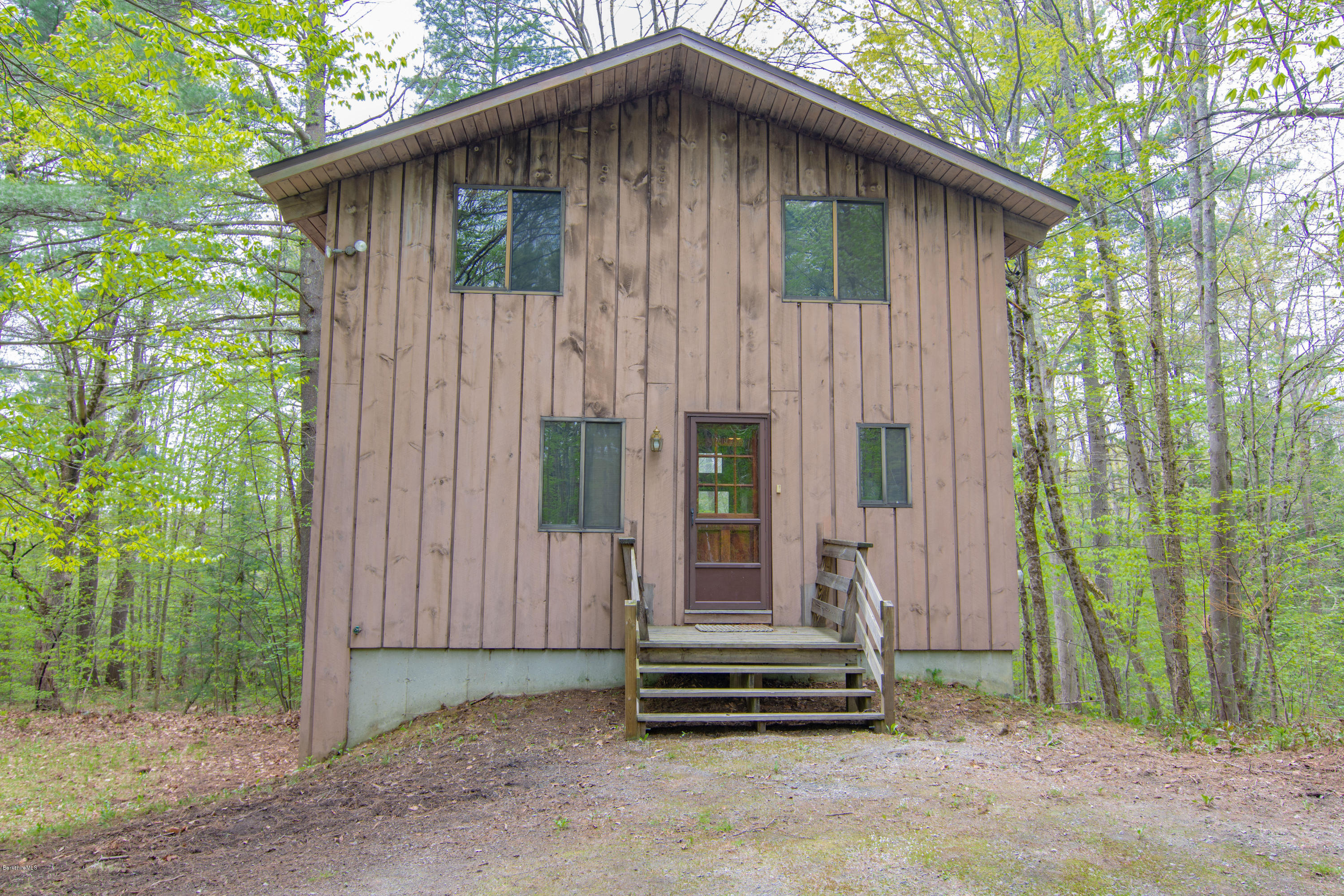 673 West Center Road Otis, MA 01253 - Photo 1 of 23 a front view of a house with a garden