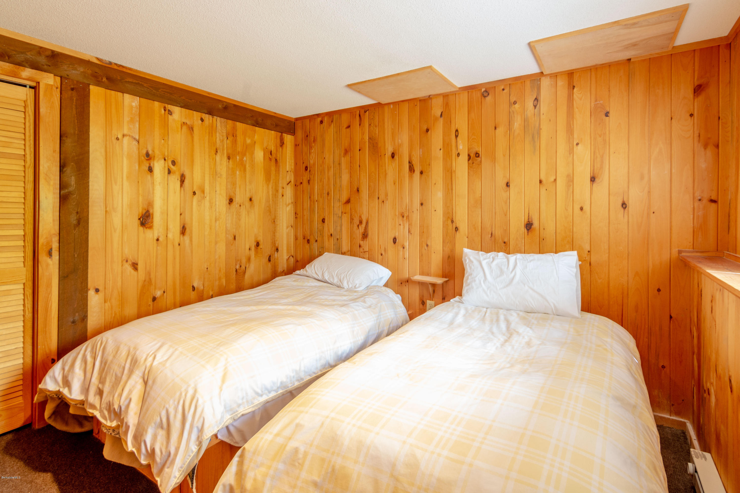673 West Center Road Otis, MA 01253 - Photo 17 of 23 a bedroom with a bed and curtain