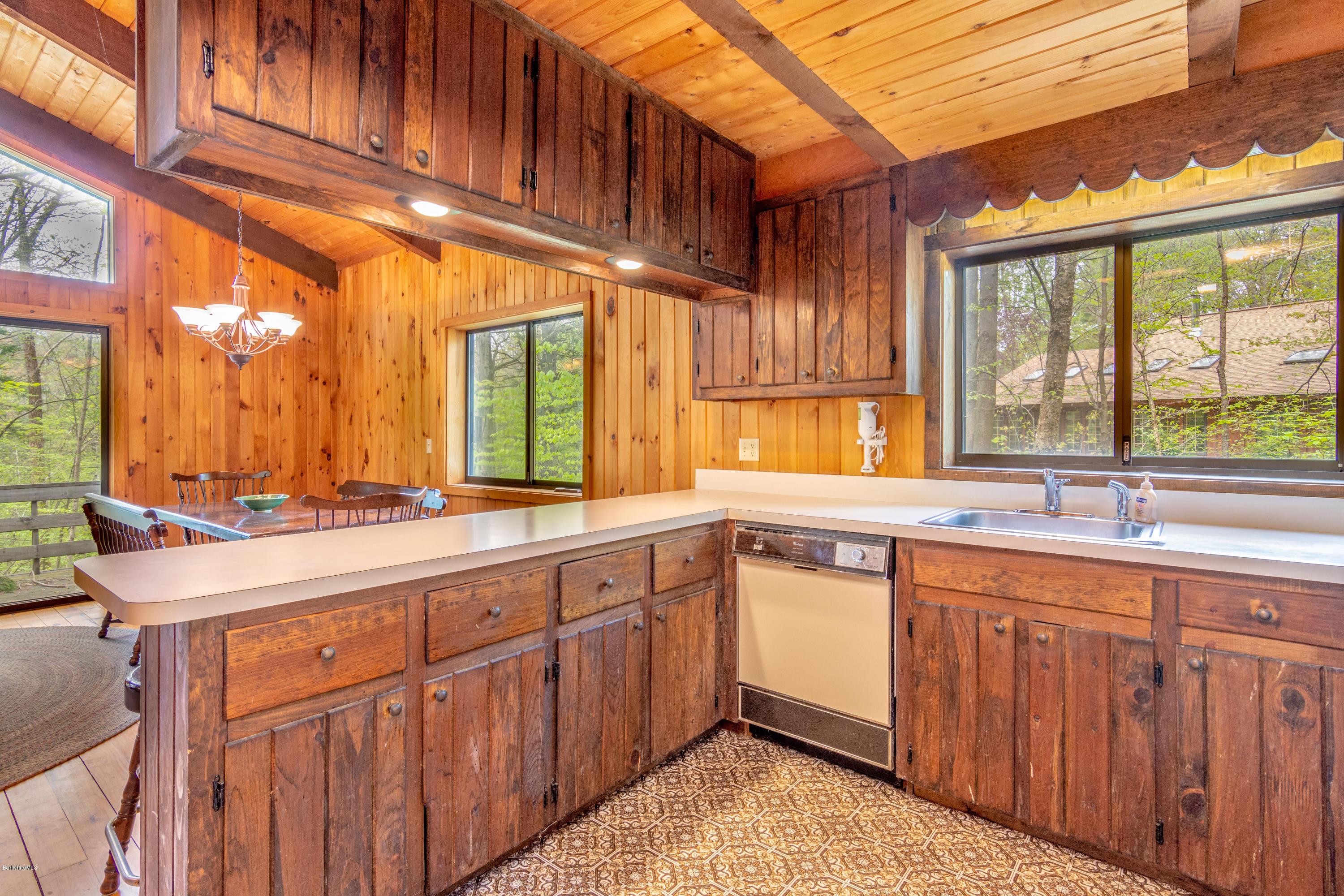 673 West Center Road Otis, MA 01253 - Photo 3 of 23 a kitchen with kitchen island granite countertop a sink appliances cabinets and a large window