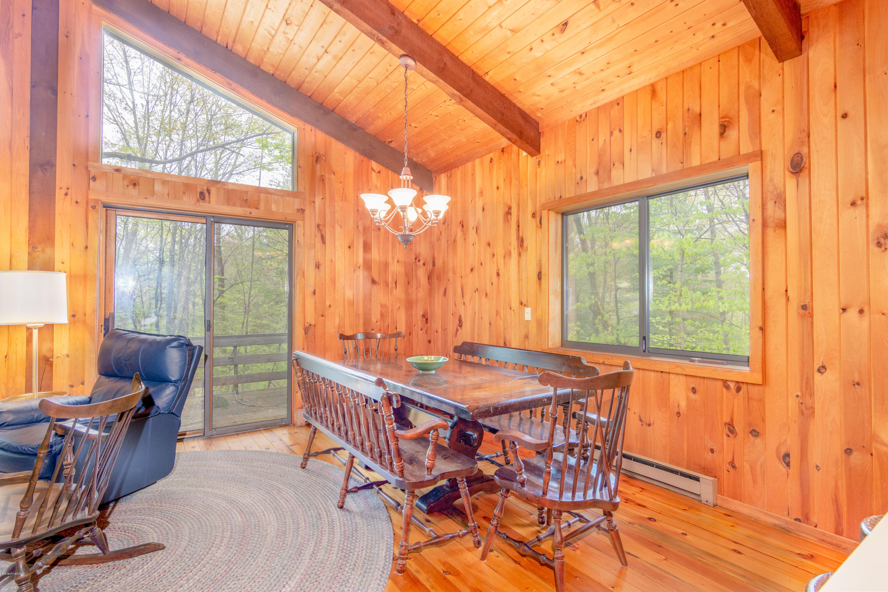 673 West Center Road Otis, MA 01253 - Photo 4 of 23 a dining room with furniture large windows and wooden floor