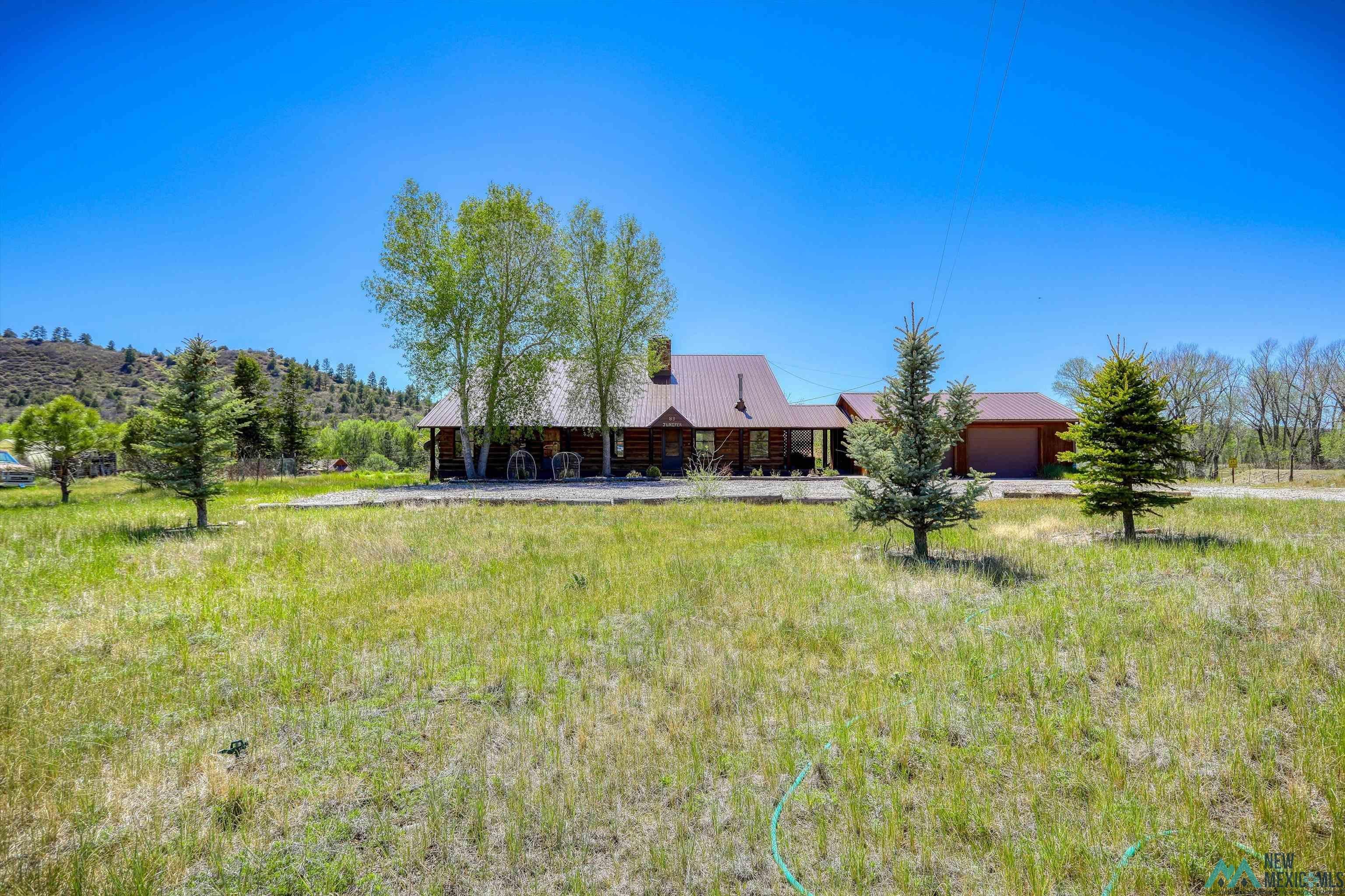 83 Juniper Road Chama, NM 87520 - Photo 49 of 56 Log-style residence featuring a metal roof and an attached garage