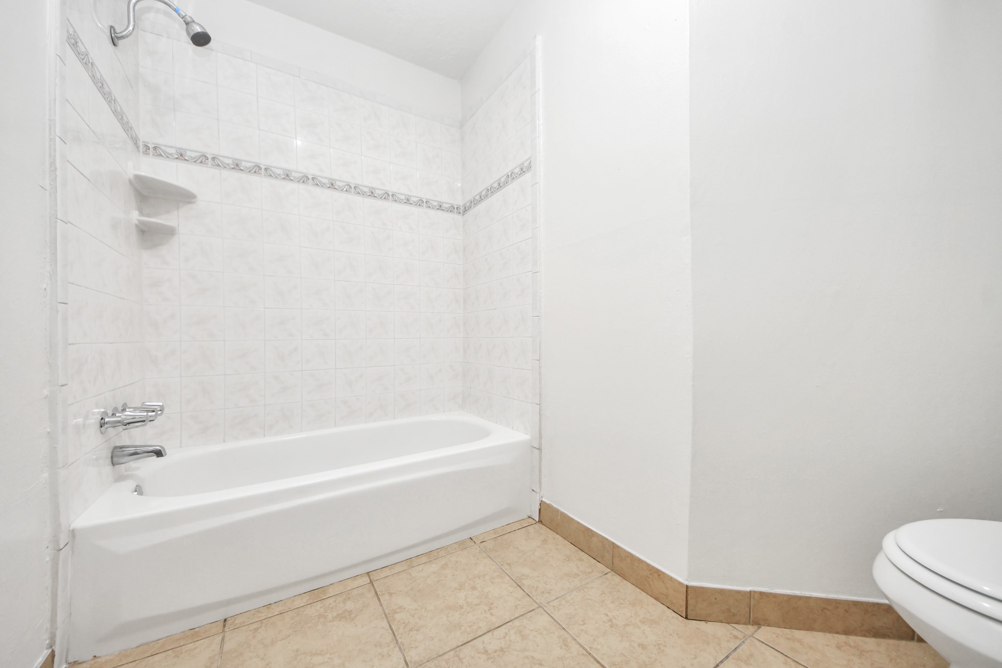 6603 Brookgate Drive Spring, TX 77373 - Photo 13 of 22 a bathroom with a bathtub and a toilet