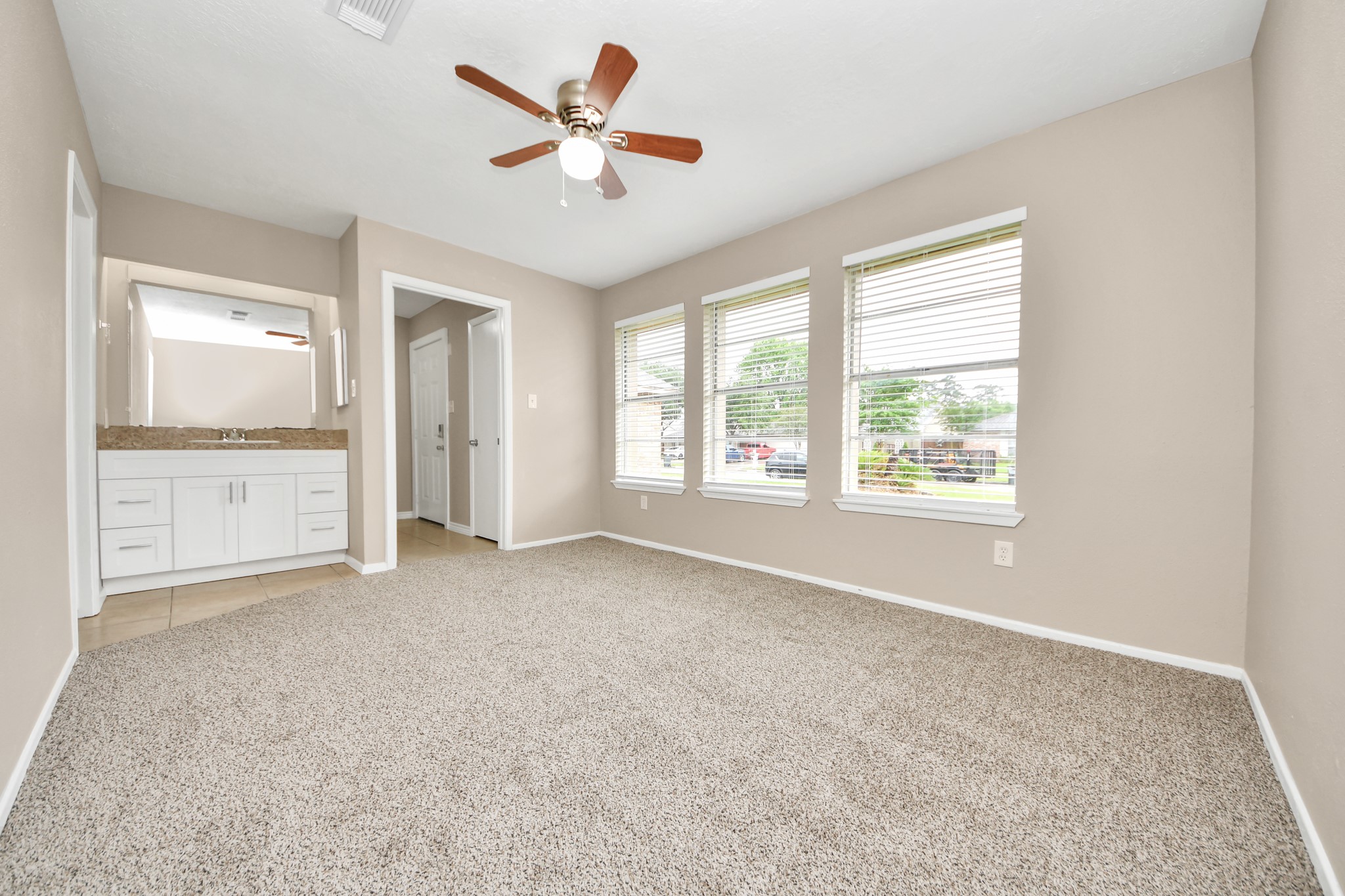6603 Brookgate Drive Spring, TX 77373 - Photo 14 of 22 an empty room with chandelier fan and windows