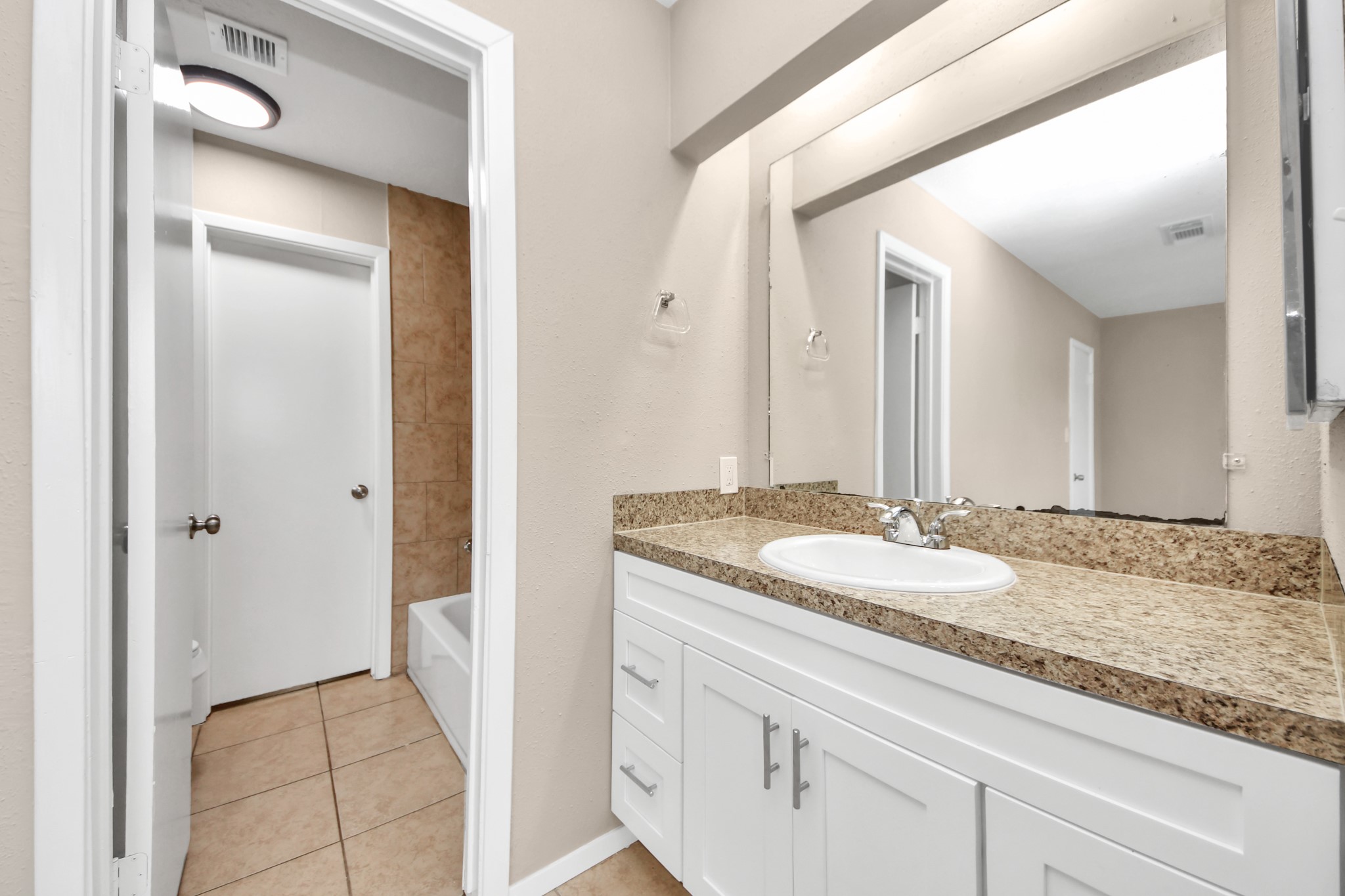 6603 Brookgate Drive Spring, TX 77373 - Photo 15 of 22 a en suite bathroom with a granite countertop sink and a mirror