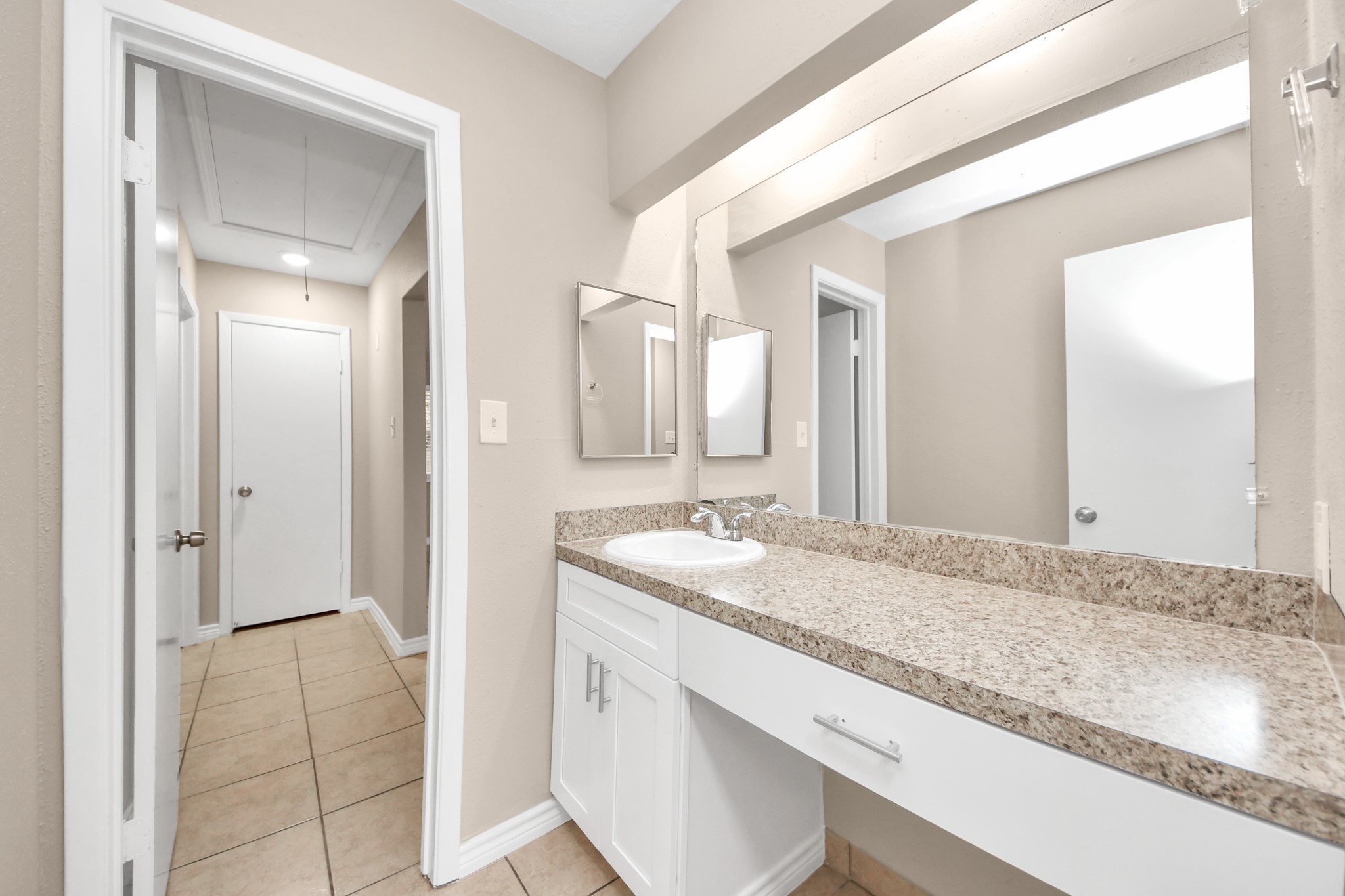 6603 Brookgate Drive Spring, TX 77373 - Photo 17 of 22 a bathroom with a granite countertop sink and a mirror