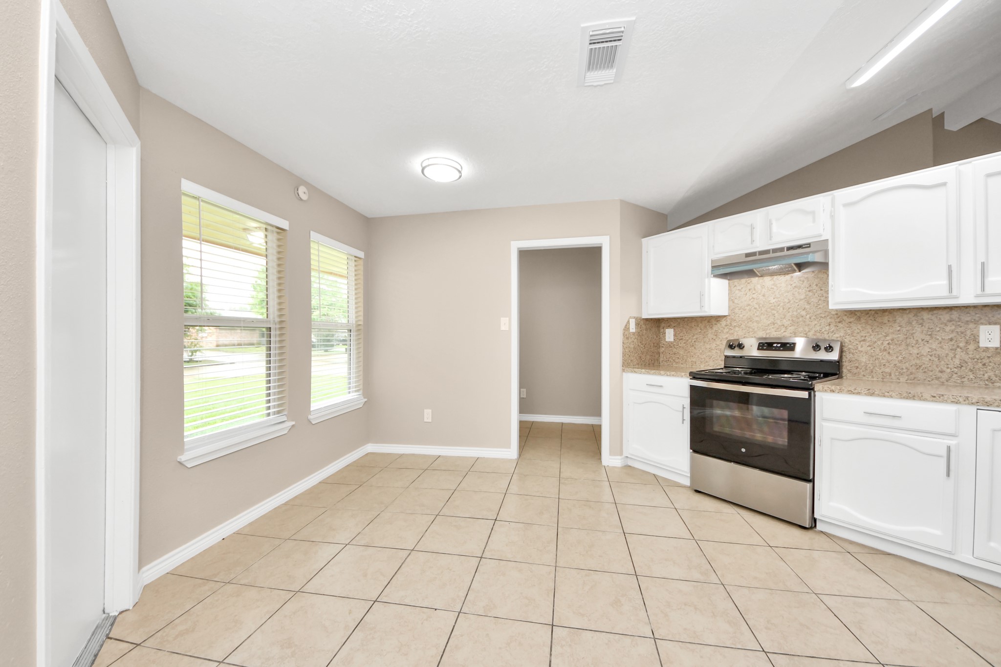 6603 Brookgate Drive Spring, TX 77373 - Photo 7 of 22 a kitchen with a stove a sink and a refrigerator