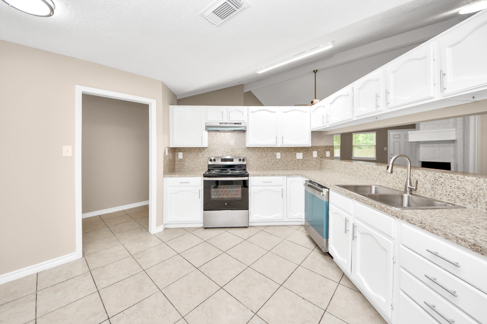 6603 Brookgate Drive Spring, TX 77373 - Photo 8 of 22 a kitchen with granite countertop white cabinets and white appliances