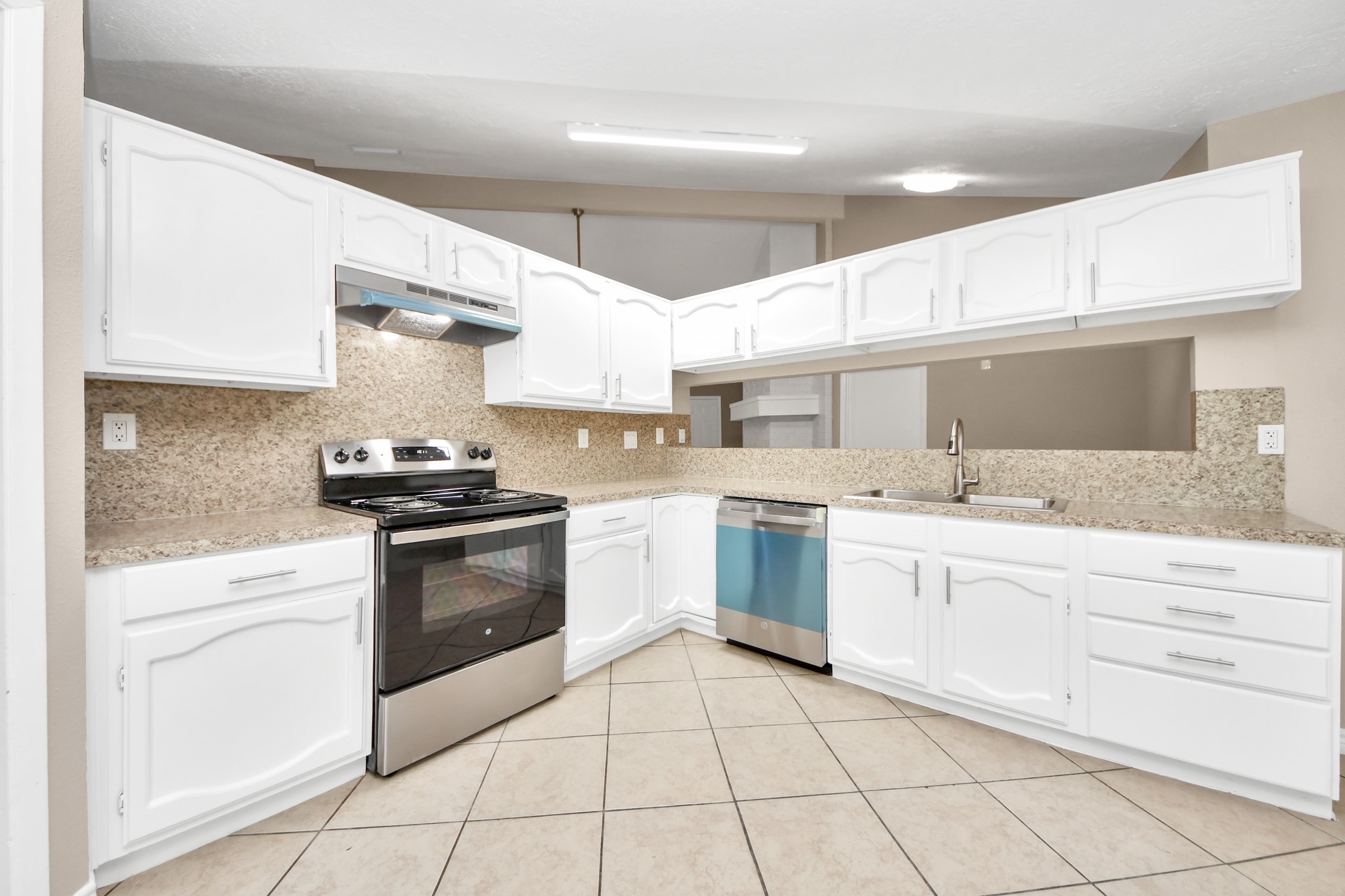 6603 Brookgate Drive Spring, TX 77373 - Photo 10 of 22 a kitchen with a stove sink and cabinets
