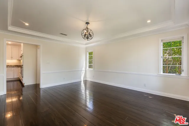 a kitchen with granite countertop kitchen island white cabinets and appliances