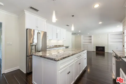 a kitchen with stainless steel appliances granite countertop a sink and a counter space