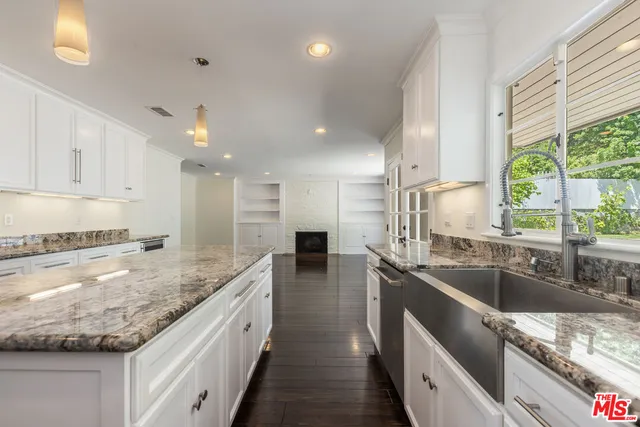 a kitchen with stainless steel appliances granite countertop a sink a stove and a granite counter tops