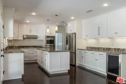 a view of kitchen with a table and chairs