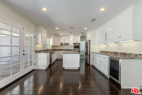 a view of kitchen with wooden floor and windows