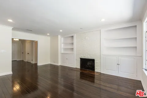 a bathroom with a granite countertop sink a toilet a mirror and shower