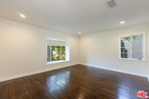 a bathroom with a granite countertop sink a toilet and a mirror