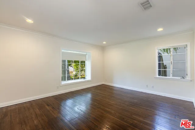 a bathroom with a granite countertop sink a toilet and a mirror