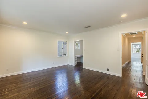 a spacious bathroom with a tub sink and mirror