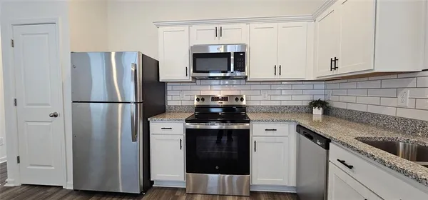 a kitchen with a sink and a refrigerator
