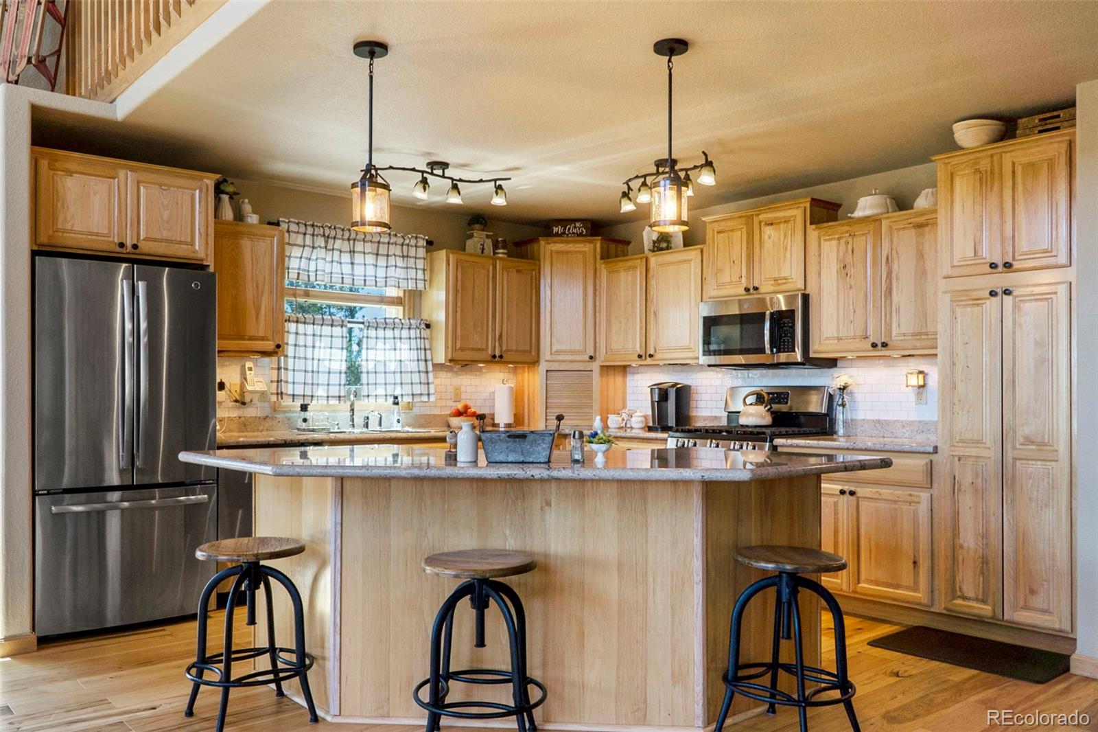 378 Silver Heels Circle Fairplay, CO 80440 - Photo 11 of 40 a kitchen with stainless steel appliances granite countertop a stove a refrigerator and a wooden floors